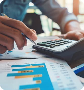 Hand using calculator on financial report